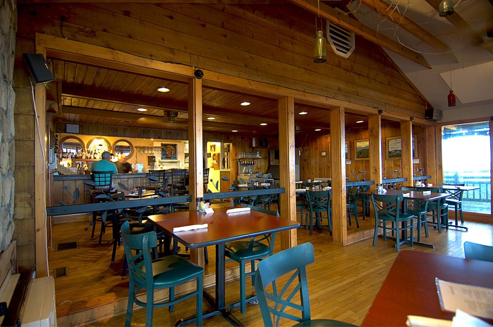 Mountain restaurant with panoramic views and deck seating.